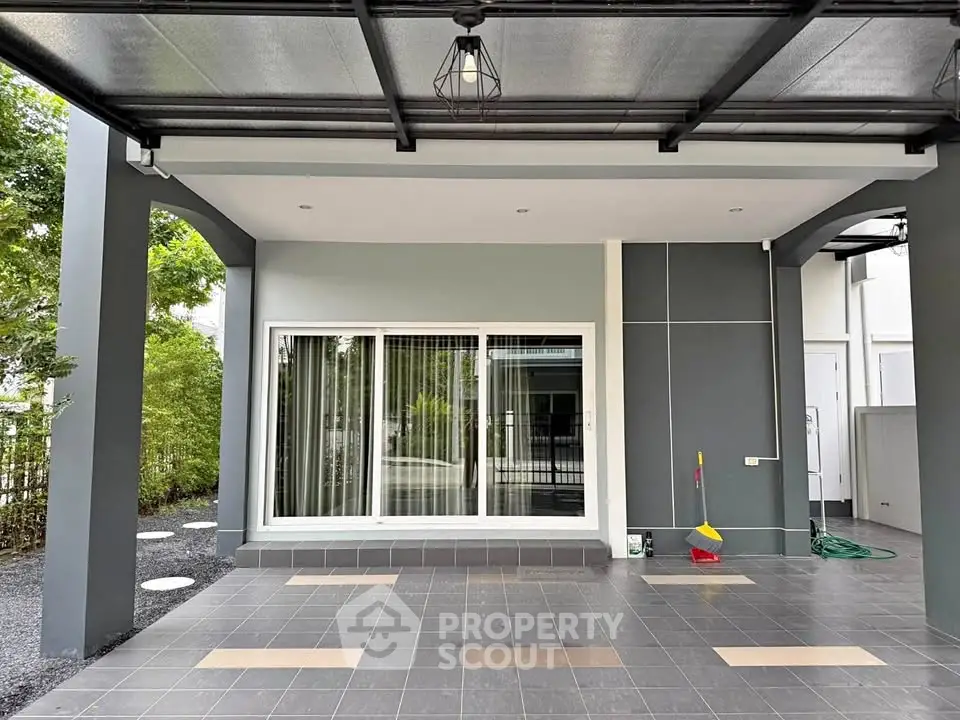 Modern home exterior with covered patio and sliding glass doors