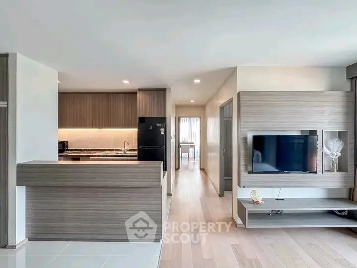 Modern open-plan living room with sleek kitchen and stylish decor