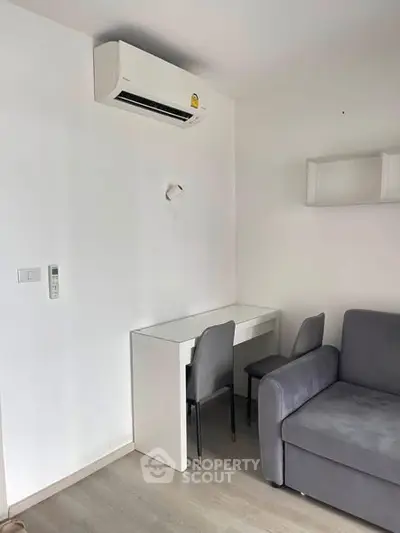 Modern living room with sleek furniture and air conditioning, perfect for comfortable urban living.