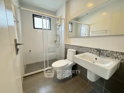 Modern bathroom with glass shower and sleek fixtures, ideal for contemporary living.