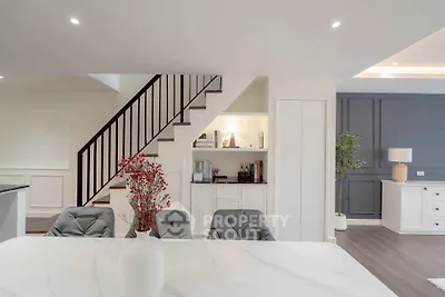 Elegant modern living space with stylish staircase and chic decor