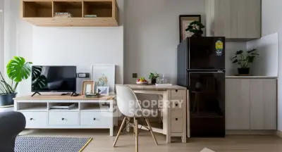 Modern living room with stylish furniture and compact kitchen area, perfect for urban living.