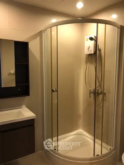 Modern bathroom with sleek shower enclosure and vanity unit