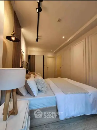 Modern bedroom with stylish decor and cozy ambiance, featuring elegant lighting and contemporary design.