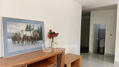 Spacious interior with modern decor and open layout, featuring a unique wall art and elegant furnishings.