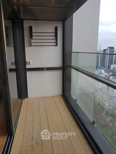 Modern balcony with city view and glass railing in high-rise building