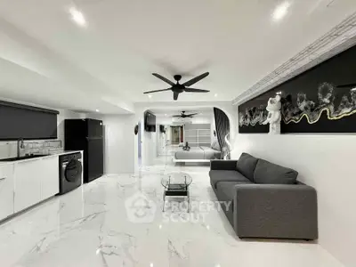 Modern living room with sleek design, marble flooring, and stylish decor in a contemporary apartment.
