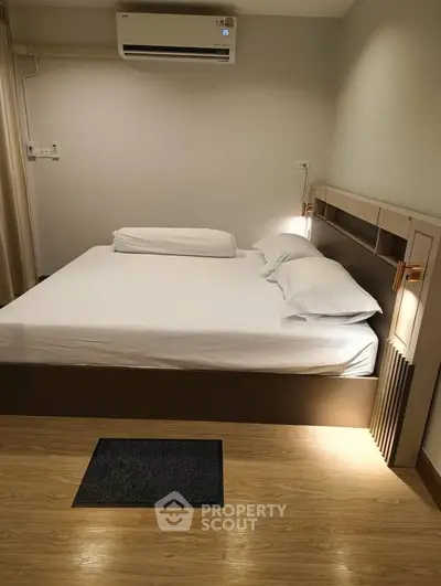 Cozy bedroom with modern design and air conditioning, perfect for relaxation and comfort.