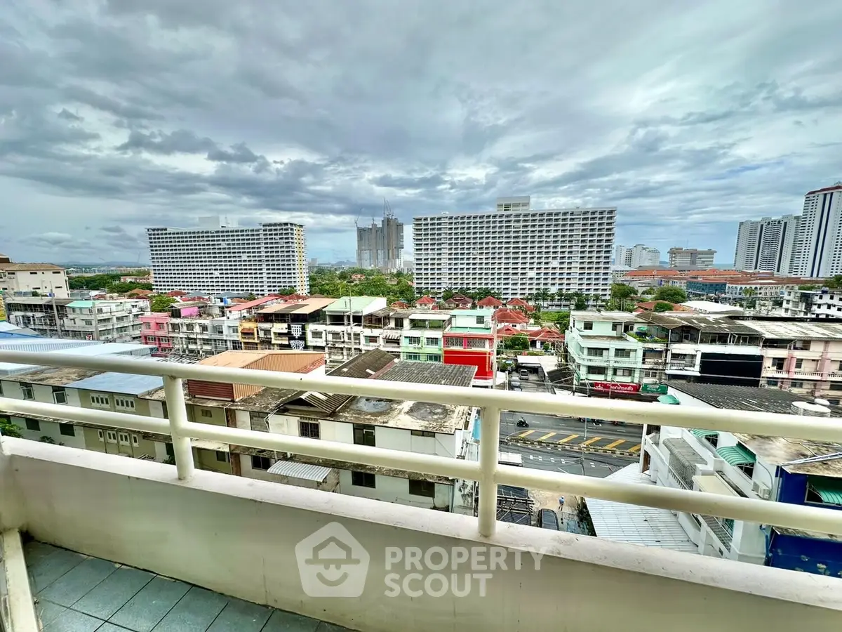 Stunning cityscape view from a high-rise balcony showcasing urban skyline and vibrant neighborhood.