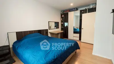 Spacious bedroom with modern decor and ample storage space.