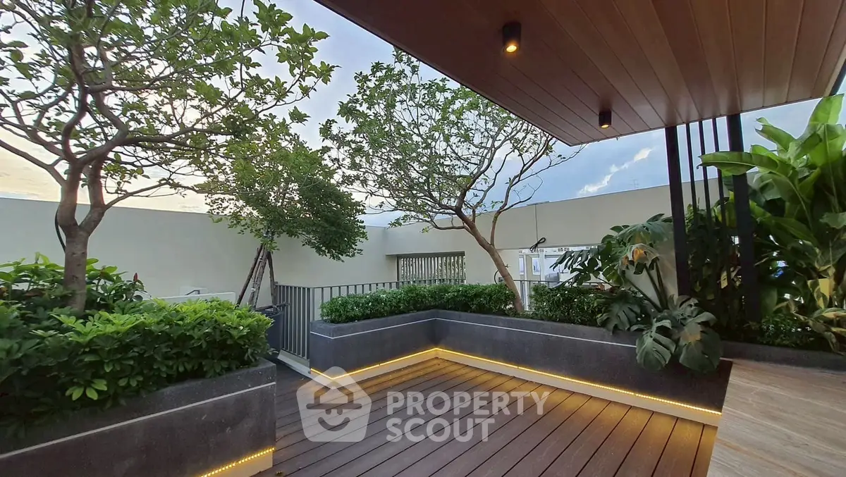 Luxurious rooftop garden with modern wooden decking and lush greenery