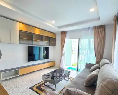 Spacious modern living room with stylish furniture and large window view.