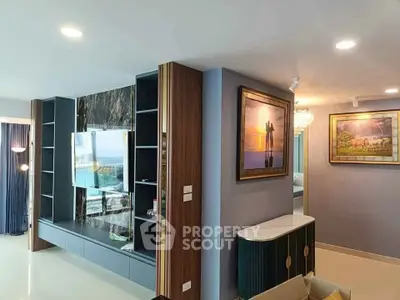 Luxurious living room with modern decor and stunning wall art, featuring a sleek entertainment center and ambient lighting.