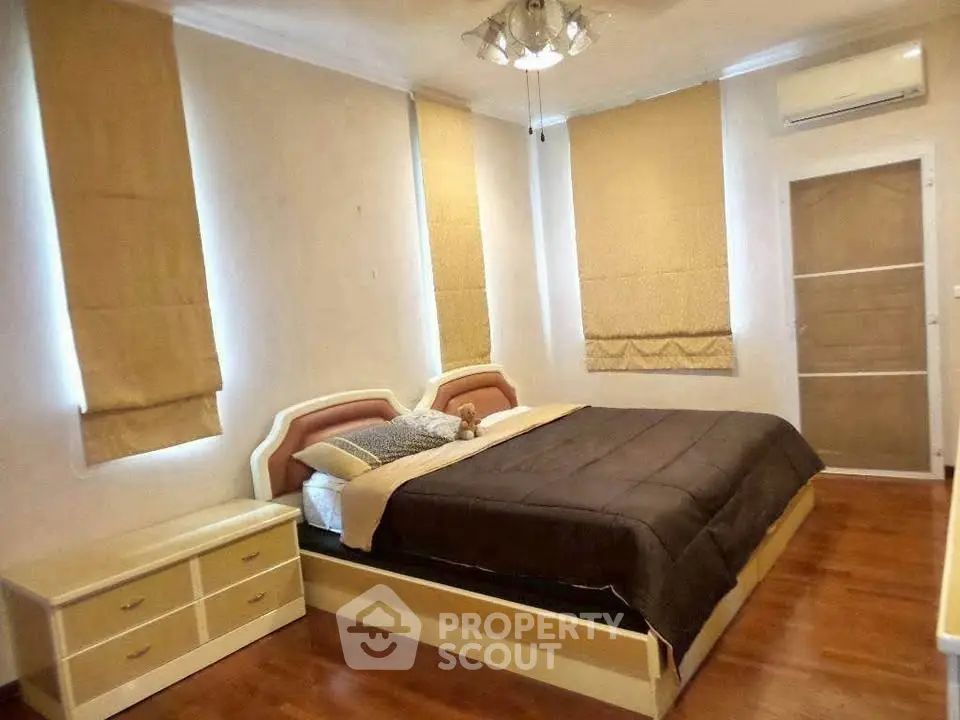 Cozy bedroom with modern furnishings and ample natural light