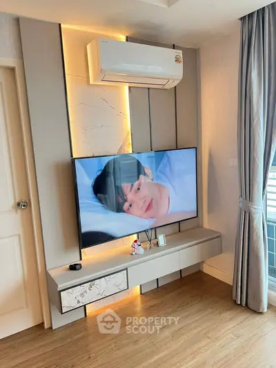 Modern living room with wall-mounted TV and air conditioning unit