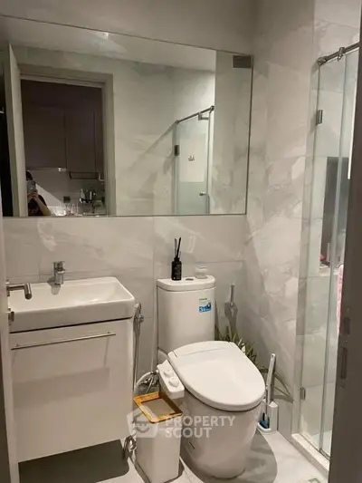 Modern bathroom with sleek fixtures and glass shower enclosure