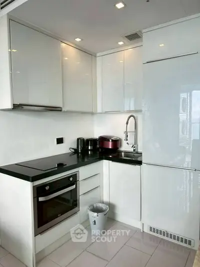 Modern kitchen with sleek white cabinets and built-in appliances