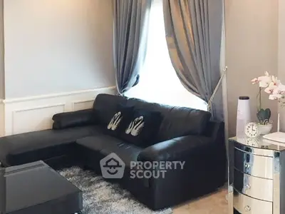 Elegant living room with black leather sofa and chic decor