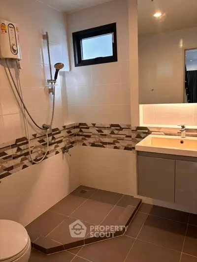 Modern bathroom with stylish tiles and walk-in shower