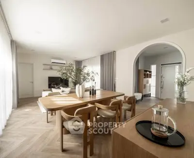 Spacious modern living room with elegant dining area and natural light