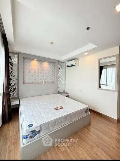 Modern bedroom with stylish decor and large windows for natural light.