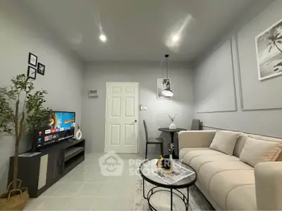 Modern living room with cozy sofa, stylish decor, and flat-screen TV for ultimate relaxation.