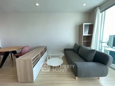 Modern living room with sleek furniture and natural light, perfect for relaxation and entertainment.