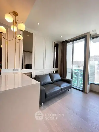 Modern living room with sleek black sofa and city view balcony