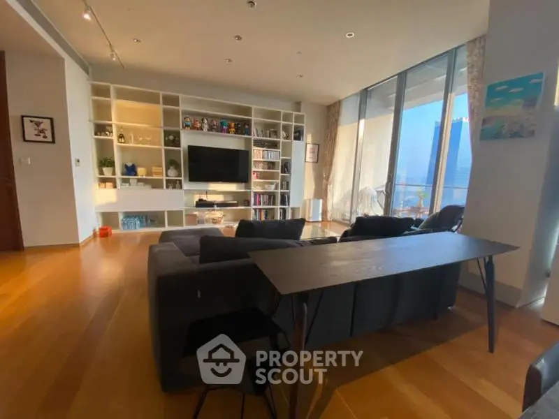 Spacious modern living room with floor-to-ceiling windows and built-in shelving.