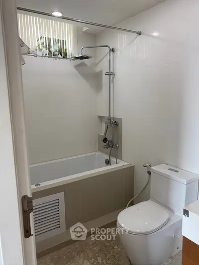 Modern bathroom with bathtub and sleek fixtures in a contemporary home.