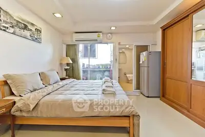 Spacious bedroom with modern amenities and cozy decor