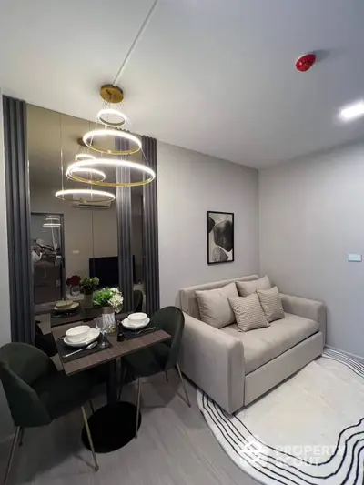 Chic modern living room with elegant furniture and stylish light fixtures, perfect for cozy urban living. The room is well-lit and tastefully decorated, creating an inviting atmosphere.