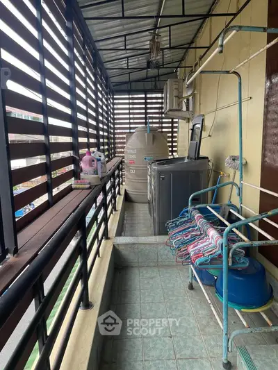 Spacious balcony with laundry area and storage space in modern apartment.