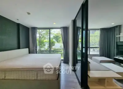 Modern bedroom with large windows and garden view in stylish apartment