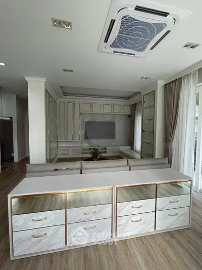 Spacious living room with modern built-in storage and elegant ceiling design