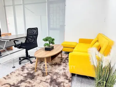 Bright office space with yellow sofa and modern decor