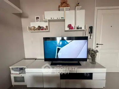 Modern living room with sleek white TV unit and stylish shelving