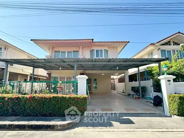 Charming two-story house with spacious driveway and lush garden in a serene neighborhood.