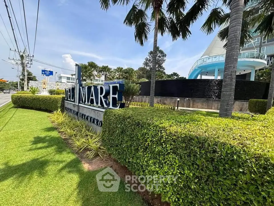 Luxurious beachfront condominium with lush landscaping and modern architecture.