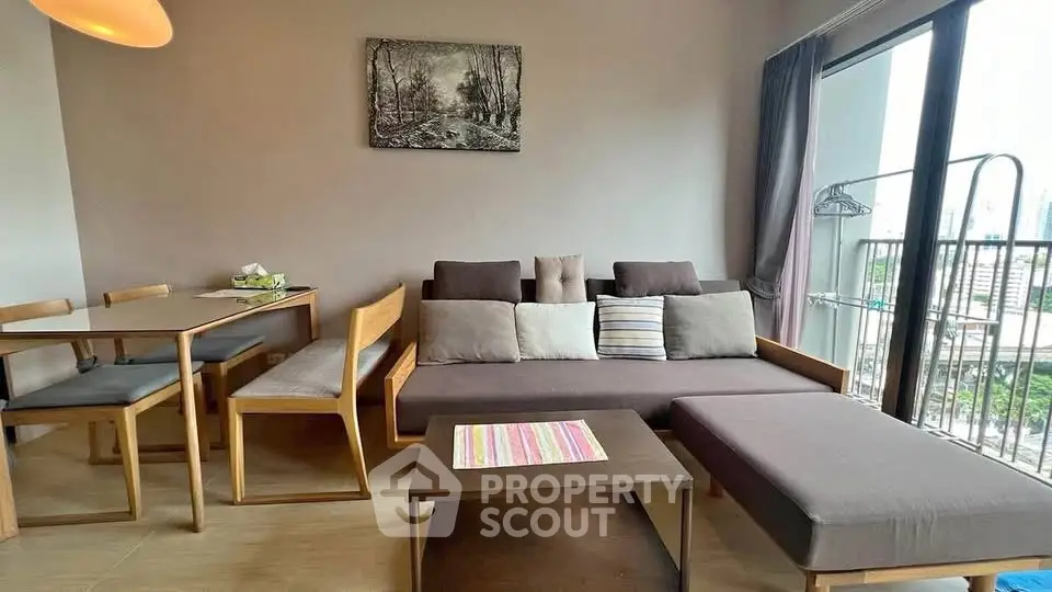Modern living room with stylish furniture and balcony view in a cozy apartment.