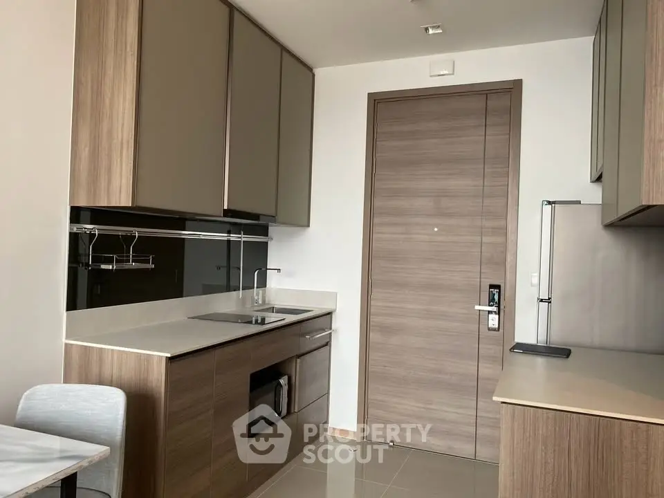 Modern kitchen with sleek cabinetry and integrated appliances in a stylish apartment.