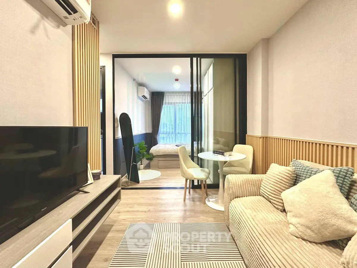 Modern living room with cozy seating and stylish decor in a contemporary apartment.