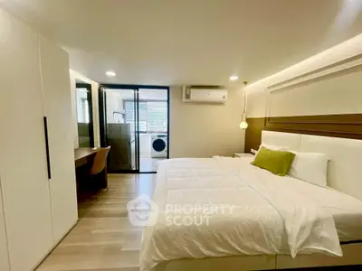 Modern bedroom with ensuite study and laundry area, featuring sleek design and ample natural light.