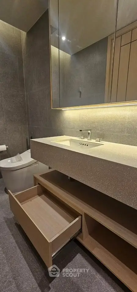 Modern bathroom with sleek vanity and open drawer in luxury apartment