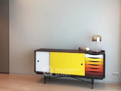 Stylish modern sideboard with colorful doors in a contemporary living room setting.
