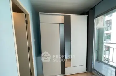 Modern bedroom with sleek wardrobe and balcony view