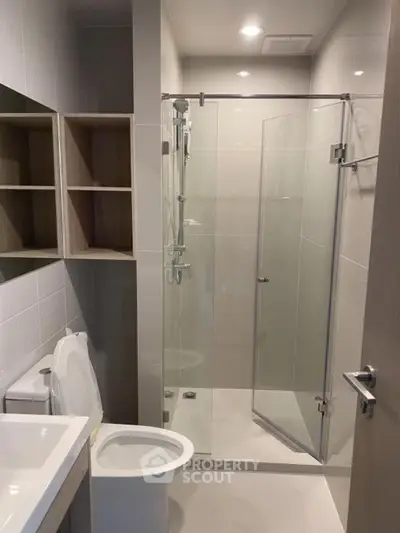 Modern bathroom with glass shower and sleek fixtures