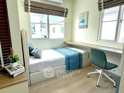 Cozy bedroom with modern decor and ample natural light