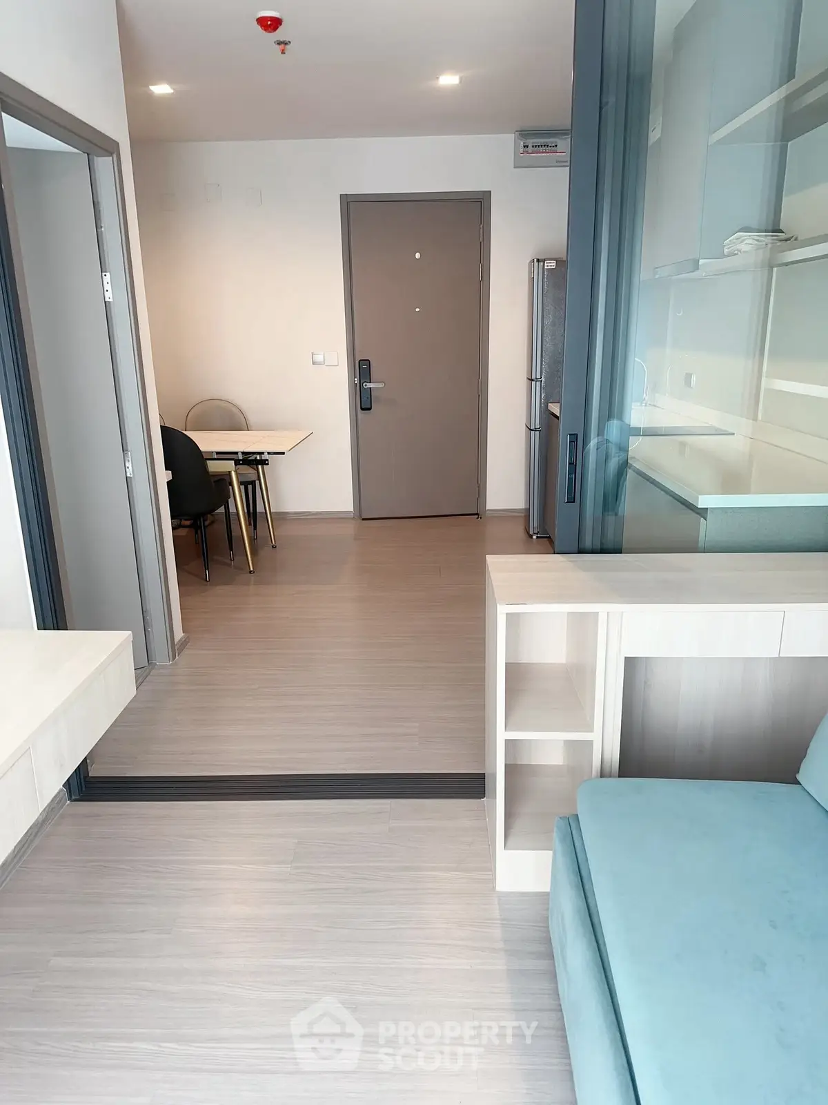 Modern apartment interior with open layout and stylish furniture, featuring a cozy living area and dining space.