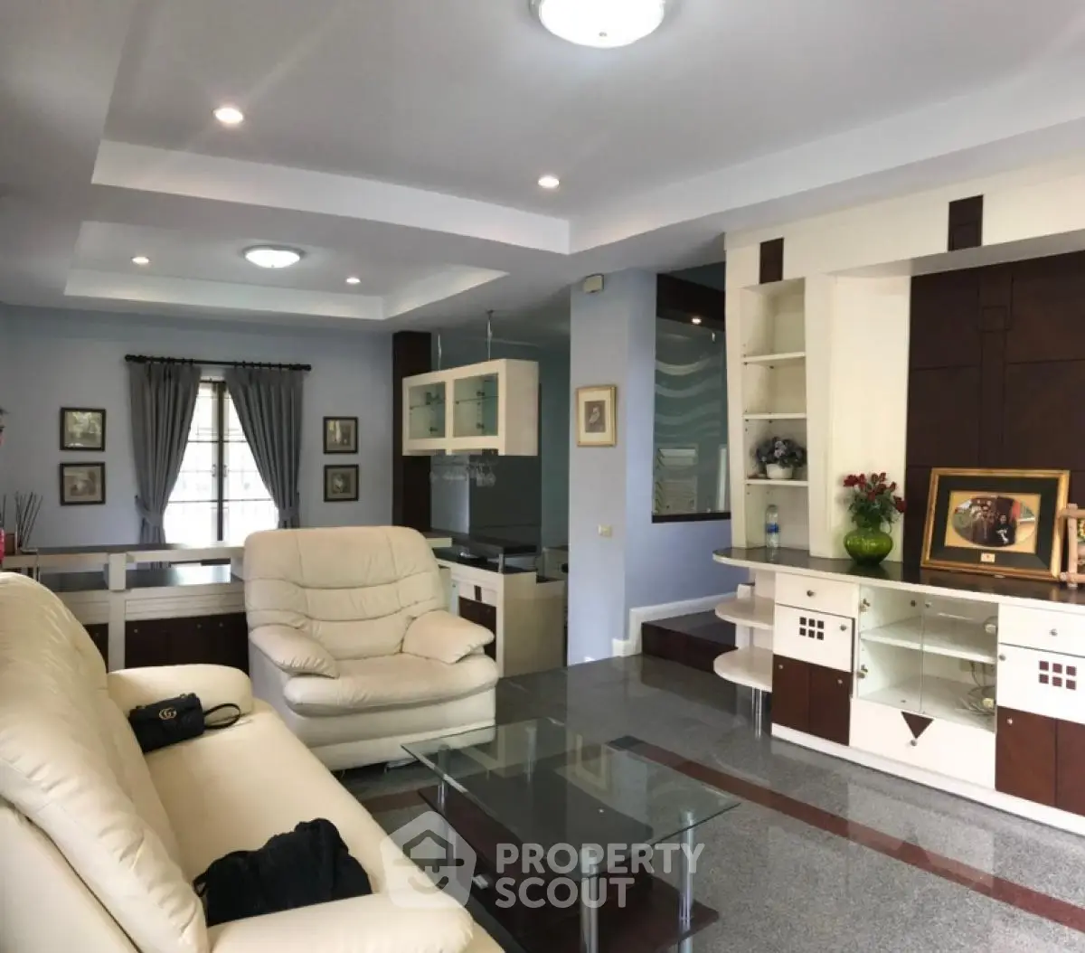 Spacious living room with modern decor and ample natural light